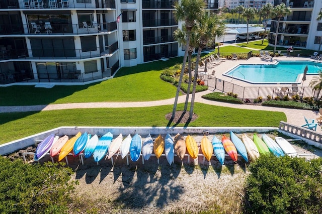 2700 N Peninsula Ave Unit 114, New Smyrna Beach, FL 32169 - pool featuring a lawn and fence