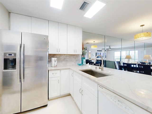 2700 N Peninsula Ave Unit 114, New Smyrna Beach, FL 32169 - kitchen featuring decorative backsplash, visible vents, dishwasher, a sink, and stainless steel fridge with ice dispenser