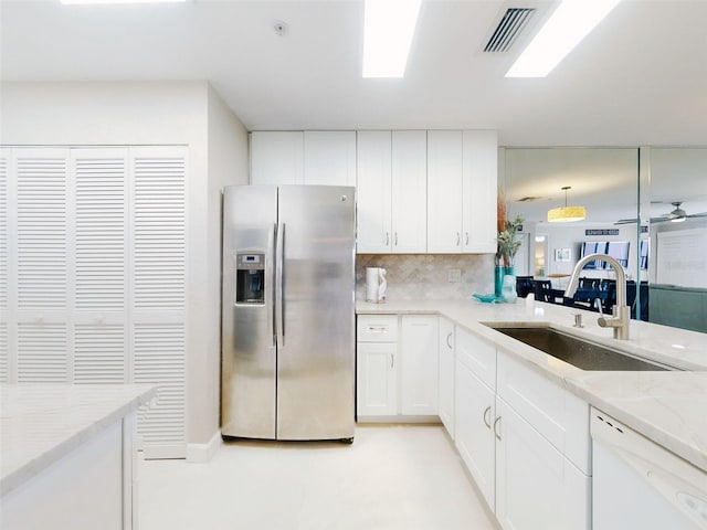 2700 N Peninsula Ave Unit 114, New Smyrna Beach, FL 32169 - kitchen with decorative backsplash, visible vents, a sink, stainless steel refrigerator with ice dispenser, and white dishwasher