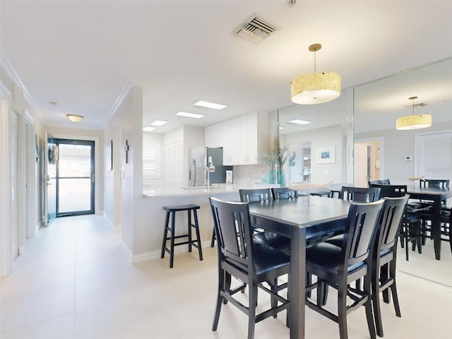 2700 N Peninsula Ave Unit 114, New Smyrna Beach, FL 32169 - dining space with baseboards, ornamental molding, and visible vents