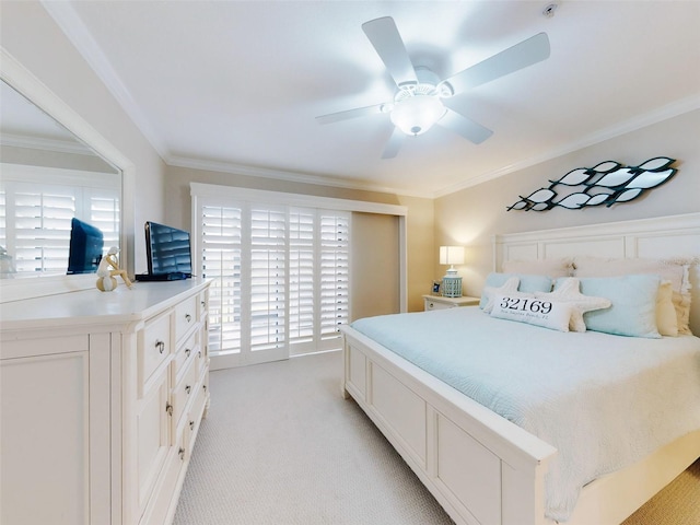 2700 N Peninsula Ave Unit 114, New Smyrna Beach, FL 32169 - bedroom featuring ornamental molding, ceiling fan, and light carpet