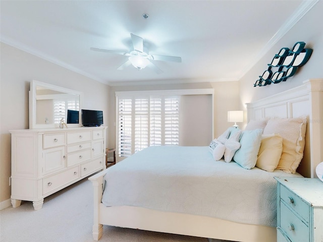 2700 N Peninsula Ave Unit 114, New Smyrna Beach, FL 32169 - bedroom with ornamental molding, ceiling fan, and light carpet