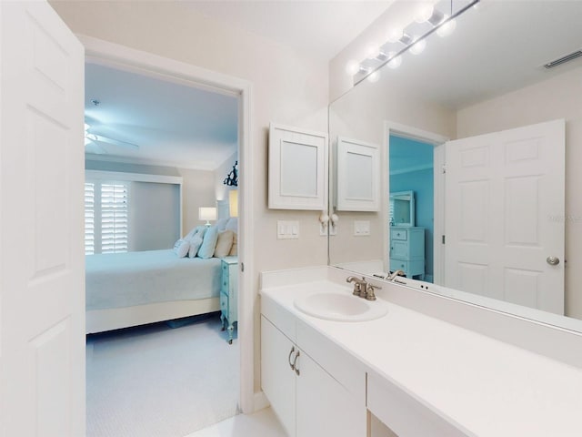 2700 N Peninsula Ave Unit 114, New Smyrna Beach, FL 32169 - ensuite bathroom featuring connected bathroom, visible vents, vanity, and a ceiling fan