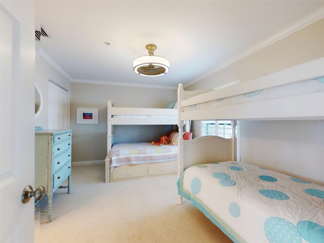 2700 N Peninsula Ave Unit 114, New Smyrna Beach, FL 32169 - bedroom with baseboards, carpet, visible vents, and ornamental molding