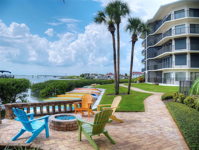 2700 N Peninsula Ave Unit 114, New Smyrna Beach, FL 32169 - view of patio with a water view and a fire pit