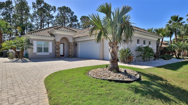 2904 Palma Ln, New Smyrna Beach, FL 32168 - mediterranean / spanish-style house featuring stucco siding, curved driveway, an attached garage, a front yard, and a tiled roof