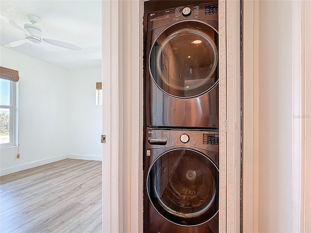 6937 Turtlemound Rd, New Smyrna Beach, FL 32169 - laundry area with stacked washing machine and dryer, wood finished floors, and a ceiling fan