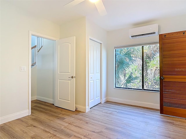 6937 Turtlemound Rd, New Smyrna Beach, FL 32169 - unfurnished bedroom featuring an AC wall unit, light wood-type flooring, and ceiling fan