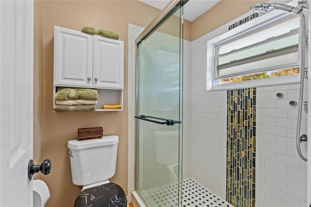full bathroom with a shower stall and toilet