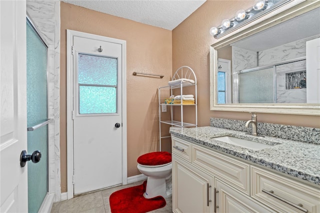 full bath with a textured ceiling, a shower stall, toilet, vanity, and a textured wall