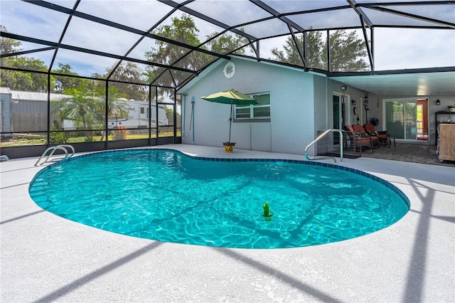 pool featuring a lanai and a patio area