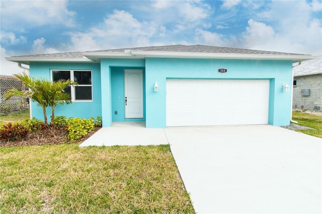 113 Douglas St, Edgewater, FL 32141 - ranch-style home with stucco siding, a front yard, a garage, and driveway