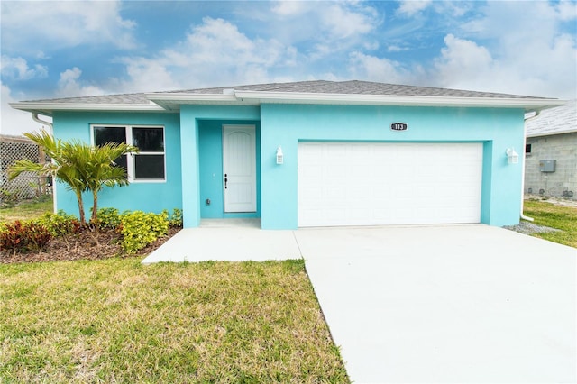 113 Douglas St, Edgewater, FL 32141 - ranch-style home with stucco siding, a front lawn, an attached garage, and driveway