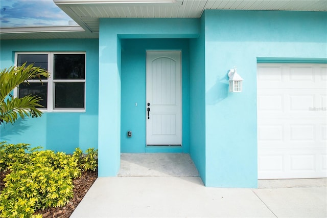 113 Douglas St, Edgewater, FL 32141 - entrance to property featuring stucco siding and a garage