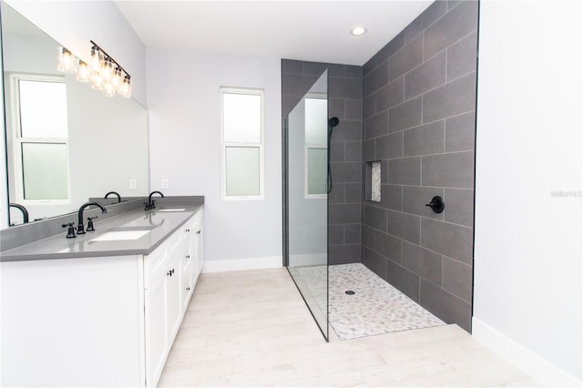 113 Douglas St, Edgewater, FL 32141 - bathroom featuring double vanity, walk in shower, baseboards, wood finished floors, and recessed lighting