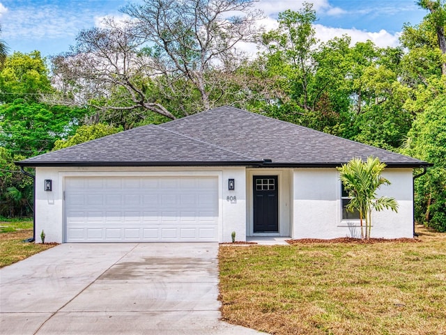 ranch-style house with concrete driveway, stucco siding, roof with shingles, an attached garage, and a front yard