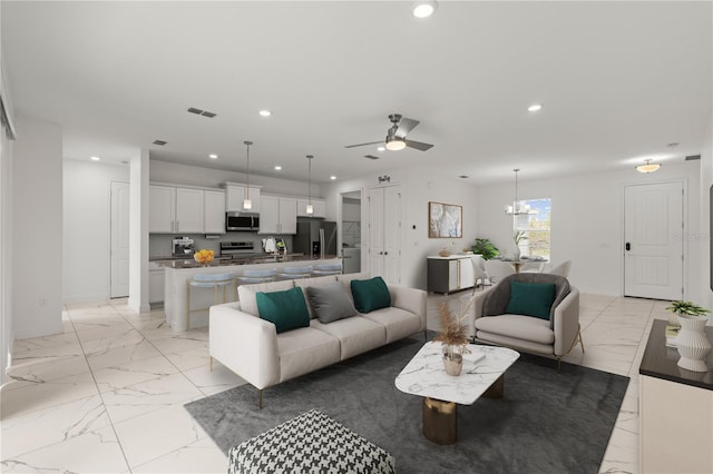 11 Lyons Pl, Palm Coast, FL 32137 - living room with recessed lighting, light marble finish floors, a ceiling fan, a chandelier, and baseboards