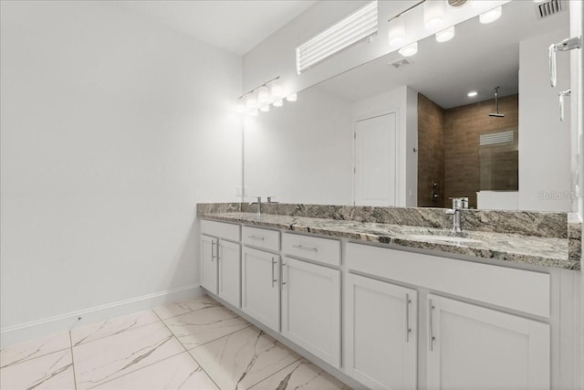 11 Lyons Pl, Palm Coast, FL 32137 - bathroom featuring marble finish floors, double vanity, a tile shower, and baseboards