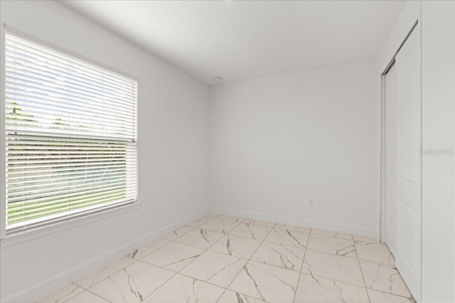 11 Lyons Pl, Palm Coast, FL 32137 - unfurnished room featuring light marble finish flooring and baseboards