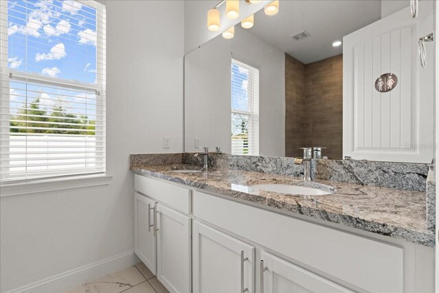 11 Lyons Pl, Palm Coast, FL 32137 - full bath with double vanity, baseboards, and marble look tiles