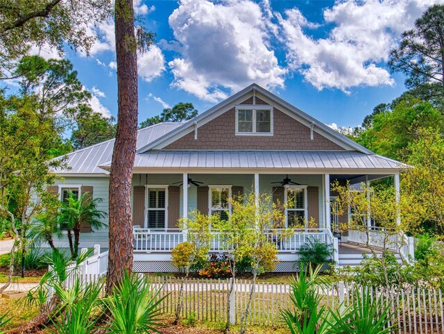 2656 Old Smyrna Trl, New Smyrna Beach, FL 32168 - view of front of property featuring metal roof, ceiling fan, a porch, and a fenced front yard