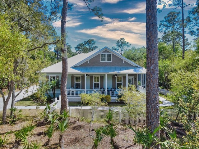 2656 Old Smyrna Trl, New Smyrna Beach, FL 32168 - view of front of property featuring metal roof, a fenced front yard, covered porch, and ceiling fan