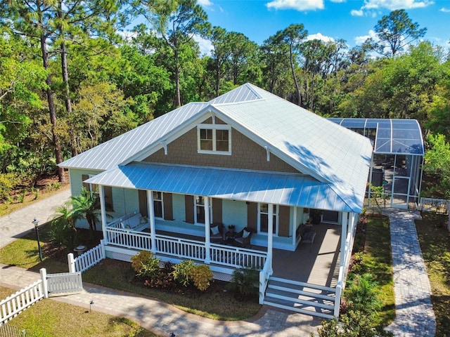 2656 Old Smyrna Trl, New Smyrna Beach, FL 32168 - view of front facade featuring covered porch, fence, and metal roof