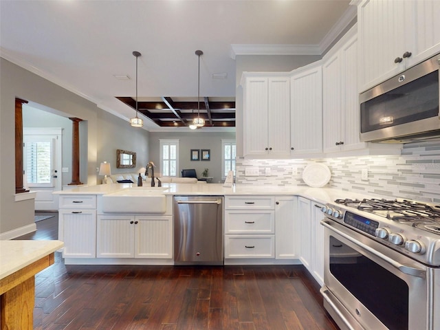 2656 Old Smyrna Trl, New Smyrna Beach, FL 32168 - kitchen featuring a peninsula, dark wood finished floors, appliances with stainless steel finishes, a sink, and coffered ceiling