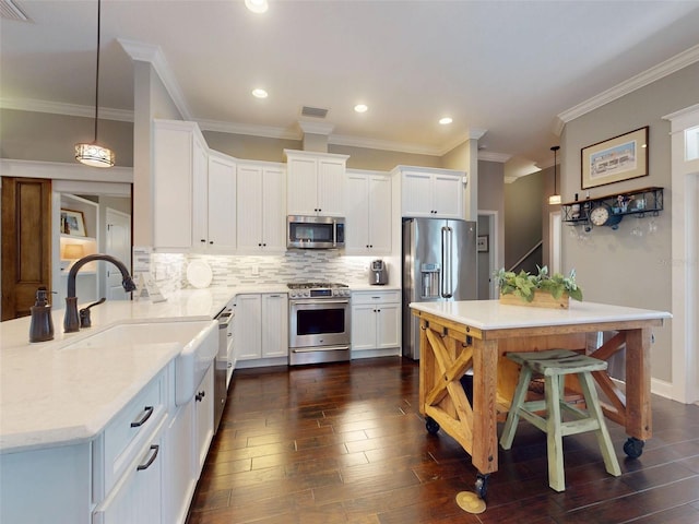 2656 Old Smyrna Trl, New Smyrna Beach, FL 32168 - kitchen with dark wood-style flooring, white cabinets, decorative backsplash, and stainless steel appliances