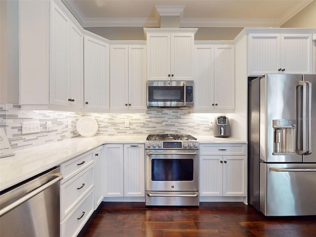 2656 Old Smyrna Trl, New Smyrna Beach, FL 32168 - kitchen featuring white cabinetry, stainless steel appliances, crown molding, and dark wood finished floors