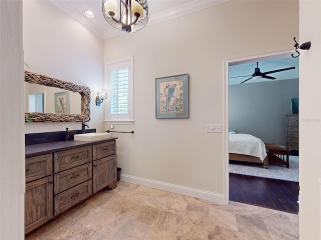 2656 Old Smyrna Trl, New Smyrna Beach, FL 32168 - ensuite bathroom featuring vanity, ceiling fan with notable chandelier, ensuite bath, baseboards, and ornamental molding
