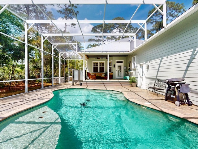 2656 Old Smyrna Trl, New Smyrna Beach, FL 32168 - outdoor pool featuring glass enclosure, ceiling fan, and a patio