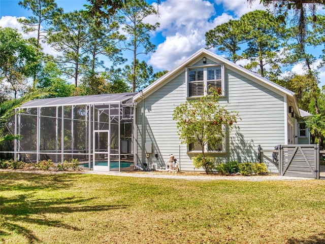 2656 Old Smyrna Trl, New Smyrna Beach, FL 32168 - rear view of property with an outdoor pool, a gate, glass enclosure, and a yard