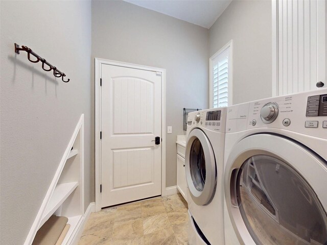 2656 Old Smyrna Trl, New Smyrna Beach, FL 32168 - laundry area featuring baseboards, separate washer and dryer, and cabinet space