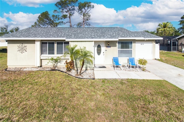 7585 Kavanda St, North Port, FL 34287 - ranch-style house with roof with shingles, an attached garage, and a front lawn