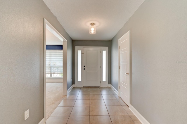 208 Lagoon Mist Ct, Oak Hill, FL 32759 - entrance foyer featuring baseboards, a textured wall, and light tile patterned floors