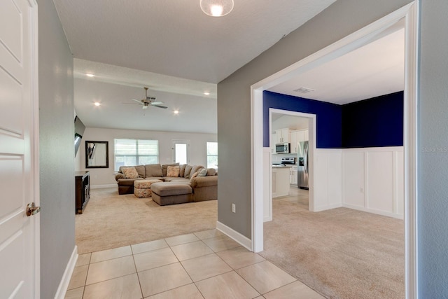 208 Lagoon Mist Ct, Oak Hill, FL 32759 - hallway featuring wainscoting, light tile patterned floors, light carpet, and visible vents