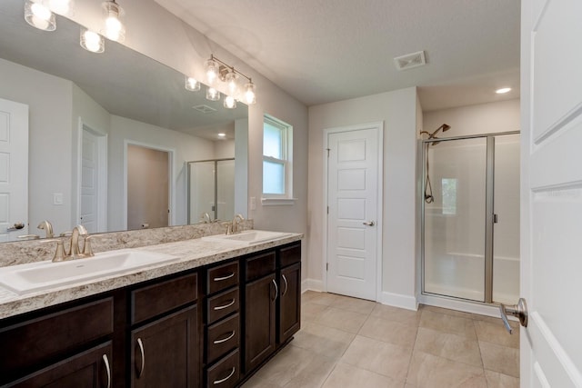 208 Lagoon Mist Ct, Oak Hill, FL 32759 - full bathroom featuring double vanity, visible vents, a sink, and a stall shower