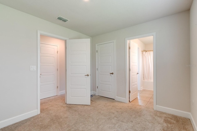 208 Lagoon Mist Ct, Oak Hill, FL 32759 - unfurnished bedroom featuring ensuite bath, carpet, baseboards, and visible vents
