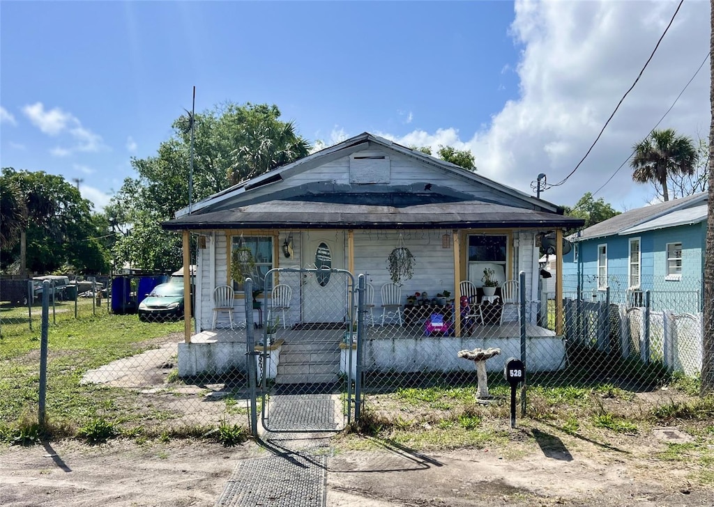 528 Ronnoc Ln, New Smyrna Beach, FL 32168 - view of front of house with a fenced front yard, a gate, and covered porch