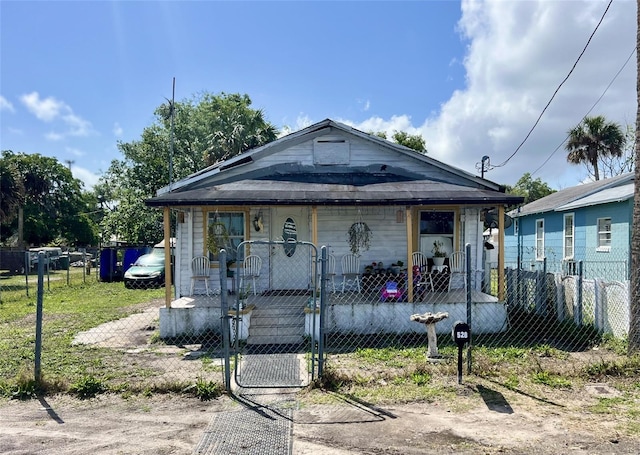 528 Ronnoc Ln, New Smyrna Beach, FL 32168 - view of front of house with a fenced front yard, a gate, and covered porch