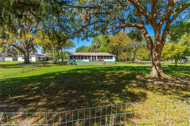191 Howes St, Oak Hill, FL 32759 - view of yard with a sunroom and fence