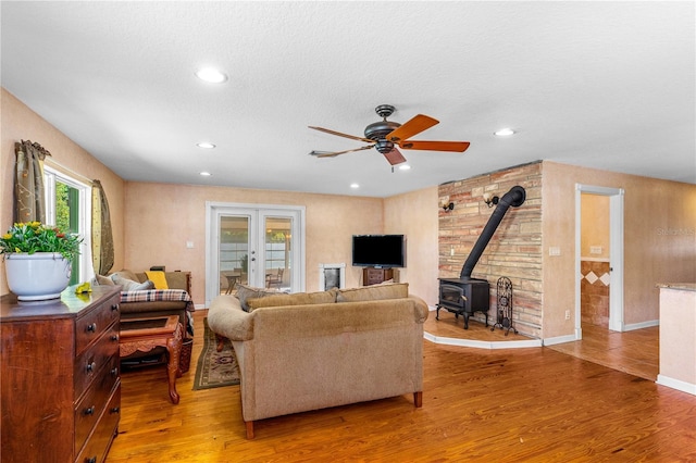 191 Howes St, Oak Hill, FL 32759 - living area featuring wood finished floors, a wood stove, ceiling fan, and recessed lighting