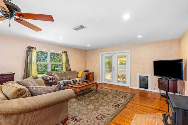 191 Howes St, Oak Hill, FL 32759 - living room with a textured ceiling, a ceiling fan, visible vents, recessed lighting, and wood finished floors