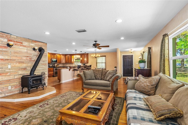 191 Howes St, Oak Hill, FL 32759 - living room featuring a wood stove, a ceiling fan, visible vents, recessed lighting, and wood finished floors