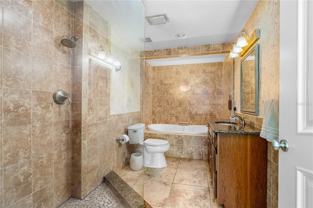 191 Howes St, Oak Hill, FL 32759 - full bath featuring tiled tub, a tile shower, tile walls, vanity, and tile patterned floors
