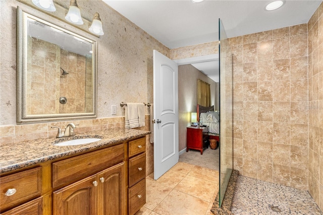 191 Howes St, Oak Hill, FL 32759 - ensuite bathroom with tile patterned floors, walk in shower, ensuite bathroom, and vanity