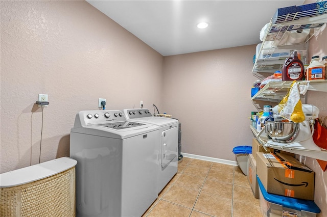 191 Howes St, Oak Hill, FL 32759 - clothes washing area featuring baseboards, laundry area, washing machine and clothes dryer, and light tile patterned flooring