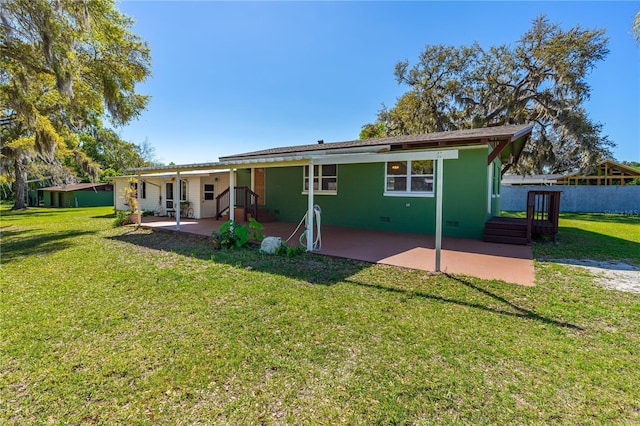 191 Howes St, Oak Hill, FL 32759 - rear view of property with a patio area and a lawn
