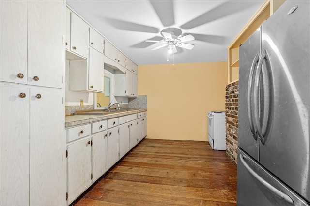 191 Howes St, Oak Hill, FL 32759 - kitchen featuring light countertops, ceiling fan, freestanding refrigerator, hardwood / wood-style flooring, and white cabinetry